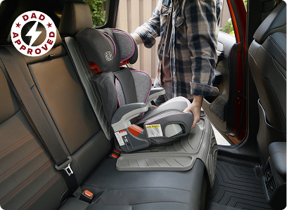 Man installing car seat on top of amige car seat protector in car backseat
