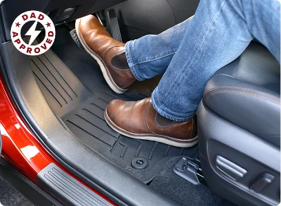 Man in boots resting feet on a Amige floorliner HP